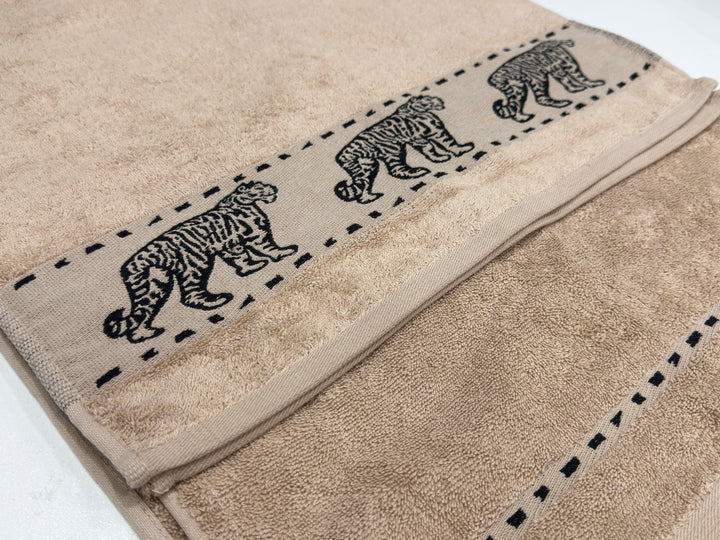 Luxury Bedsy Tigers Hand Towel displayed in a bathroom setting, soft and absorbent 100% cotton, lightweight and durable for hotel-style comfort.